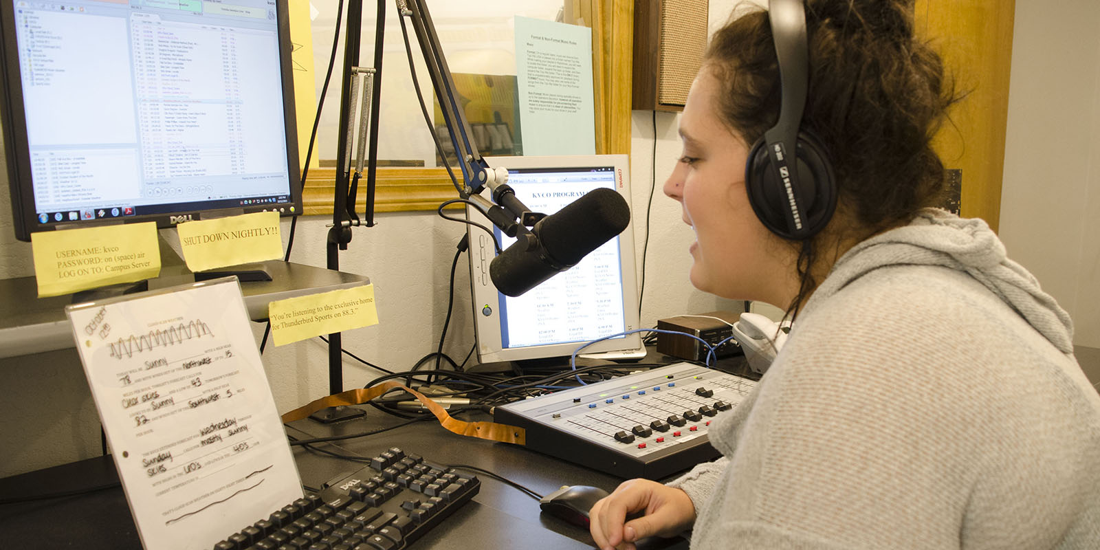 A student DJ reading a script for the radio station.