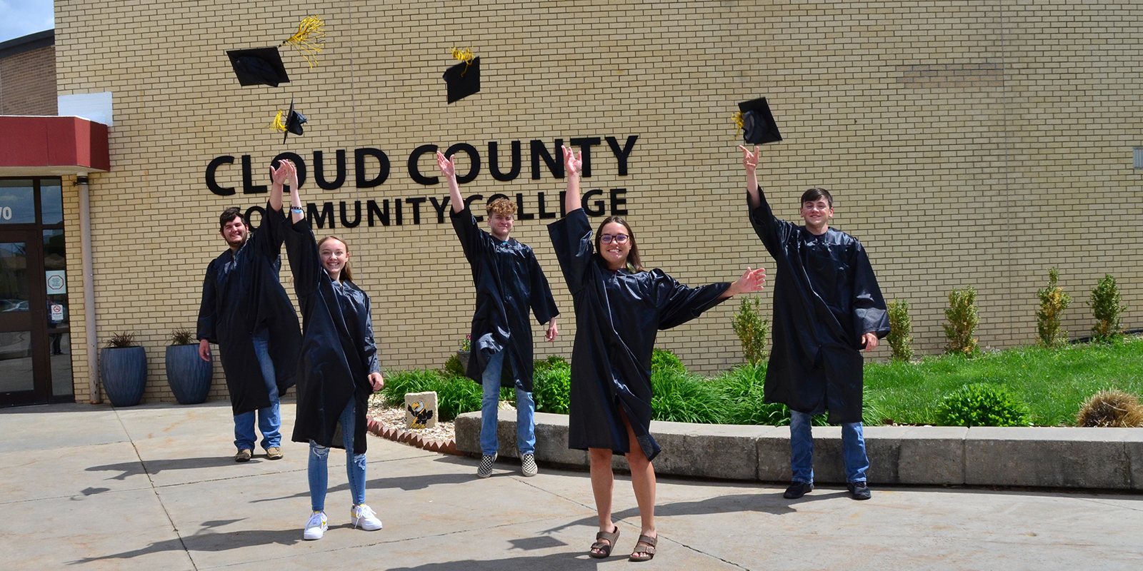 A photo of graduates tossing their caps.