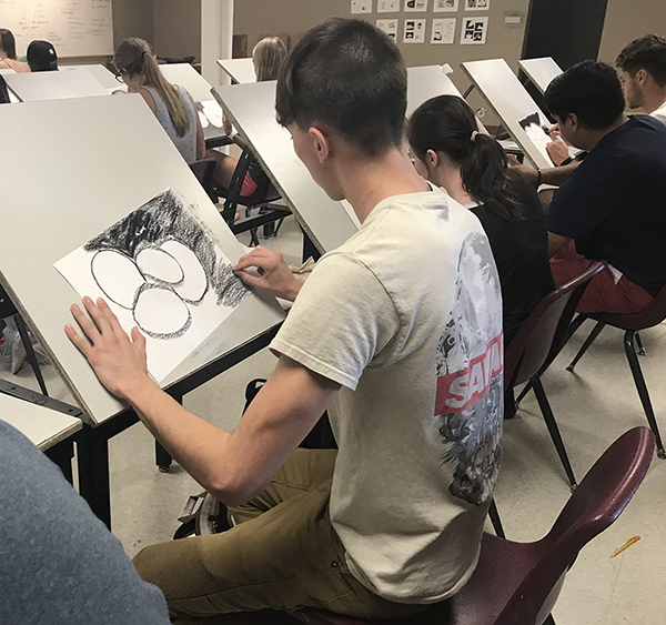 A photo of students drawing.