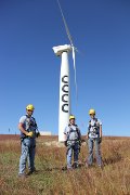 Students in safety gear standing in front of CCCC wind turbine.