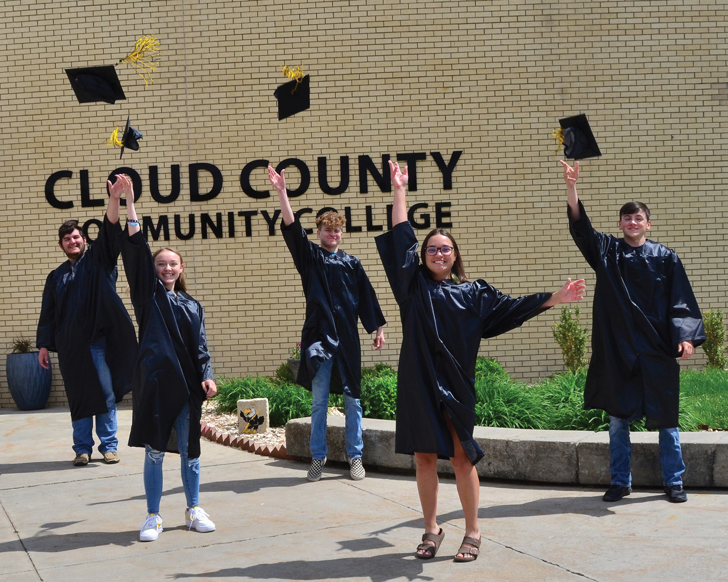 A photo of graduates tossing their caps.